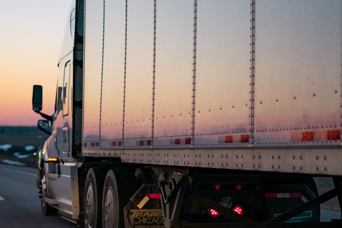 Transport truck moving units on the highway at sunset